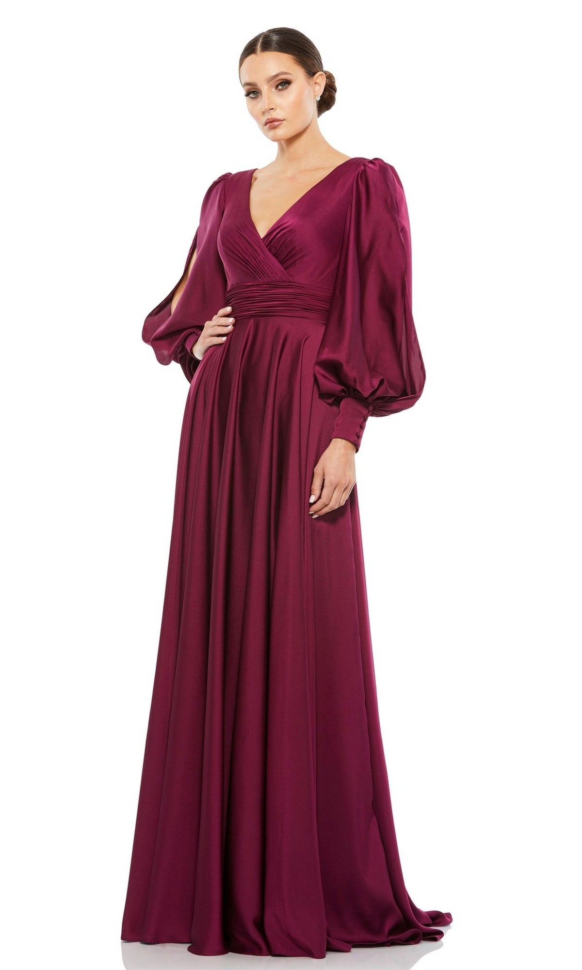 A woman stands against a white background wearing the Mac Duggal Long Formal Dress 67847, featuring a deep magenta hue, v-neckline, gathered waist, and voluminous long sleeves.